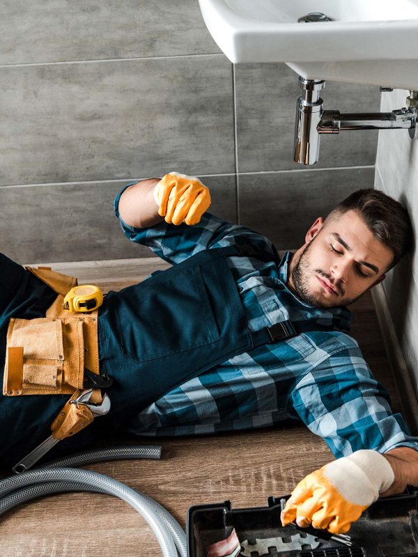 bearded handyman lying on floor near toolbox in ba resize