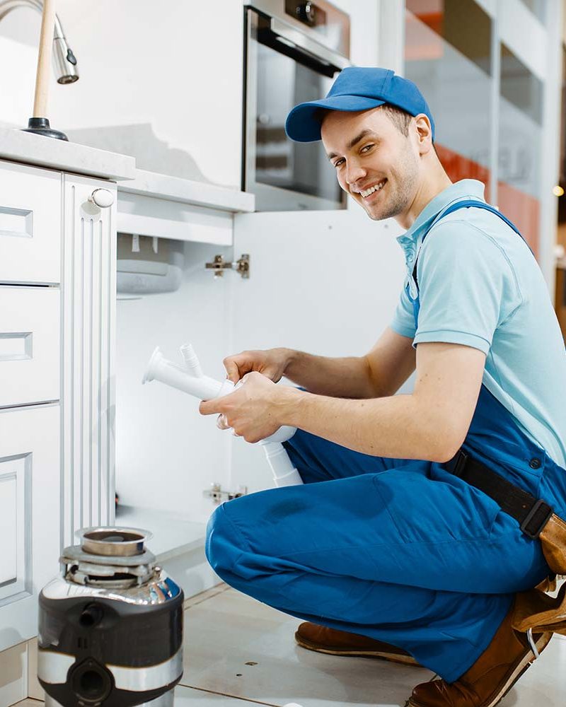 smiling male plumber in uniform holds drain pipe resize qrmyc42b2br416y7jfgabk1sft9i2vpfj6cuznhg5s